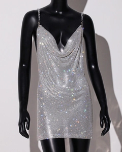 Close-up of silver sequin party dress with deep V-neck and delicate metal chain straps