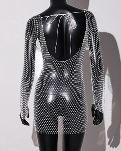Detail of long sleeve mesh mini dress with sparkling rhinestones and open back design