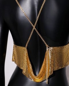 Detailed view of golden metal sequin mesh top with delicate rhinestone chain straps
