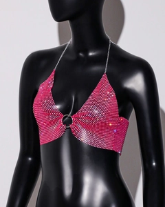 Macro shot of hot pink rhinestone halter top with silver ring connector and metal chains
