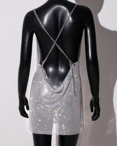 Detail view of the silver sequin backless dress featuring elegant crisscross metal chains