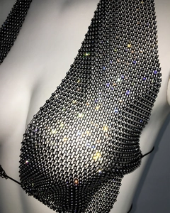 Macro shot of black metal fishnet top with sparkling rhinestones for party wear