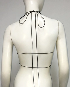 Detail of sexy black halter neck top with criss-cross back straps on a mannequin