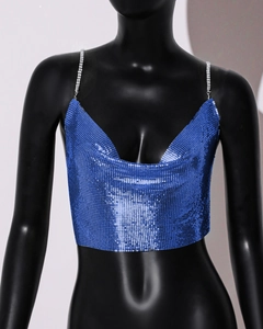 Close-up of vibrant blue metallic sequin crop top with thin chain straps and V-neckline