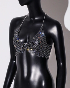 Detail of a sparkling rhinestone mesh bikini top with silver metal ring and halter neck