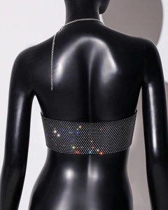 Macro detail of sparkly rhinestone mesh bandeau top with elegant metallic chain back