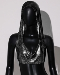 Macro detail of silver metal mesh texture on a hooded crop top with shimmering sequins
