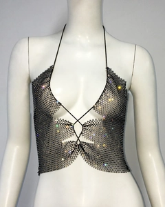 Detailed view of black halter neck top with rhinestone mesh and cross straps on mannequin