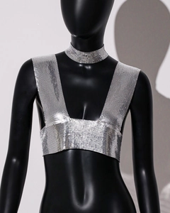 Detailed macro view of silver metal sequin mesh crop top with matching neck chain