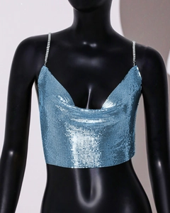 Detail of bright blue metal sequin crop top with shimmering rhinestone straps for party