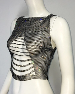 Detail of black fishnet crop top with shiny rhinestones and bold hollow cutouts