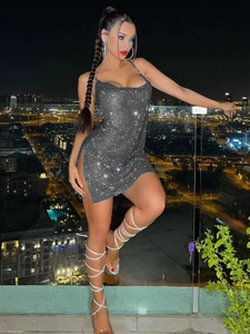 Sparkly sequin party dress with chain straps and side slit for a glamorous night look