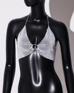 Macro detail of sparkly silver mesh sequin halter top with central metal ring link