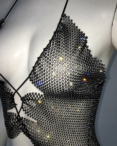 Macro shot of sparkling rhinestones on black mesh fabric for sexy women body chain top