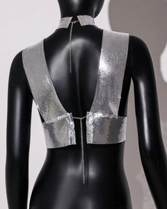 Detail of silver sequin metal crop top showing delicate back chain clasp and mesh texture