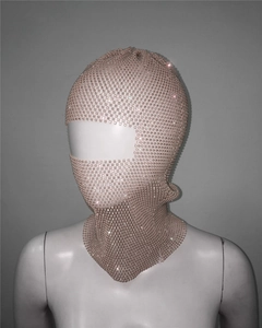 Detail of rose gold mesh balaclava mask featuring sparkling rhinestones and single eye hole