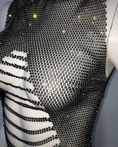 Macro shot of black mesh fabric with sparkling rhinestones on an elegant women top