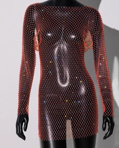 Close-up of red mesh dress featuring intricate beadwork and shimmering sequin details