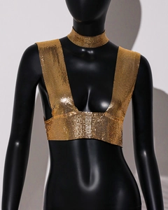 Detail of shimmering gold metal mesh sequin top and matching choker on a mannequin