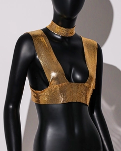 Detailed view of shimmering gold sequin mesh crop top and matching choker on a mannequin