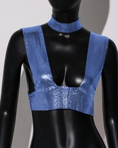 Detail of bright blue chainmail sequins crop top with a matching metallic choker