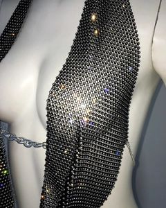 Macro detail of sexy deep V-neck black fishnet crop top with glittering rhinestones