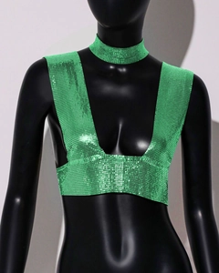 Close-up of bright green metallic sequin crop top and matching choker on a model