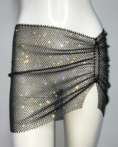 Detailed view of black rhinestone fishnet wrap skirt with shimmering crystal embellishments