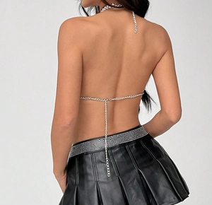 Detail view of silver metal chain halter top with backless draped design for Y2K style