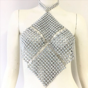 Close-up of shiny silver rhinestone mesh halter top with metallic ring connectors