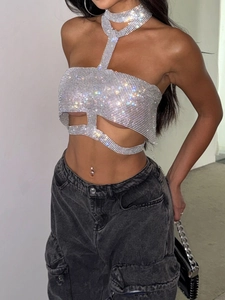 Sparkly silver rhinestone halter top paired with dark grey cargo denim jeans street style