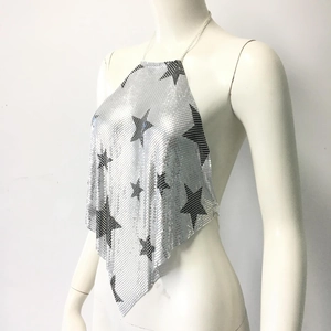 Detail of silver sequin halter top featuring black stars and metal mesh texture