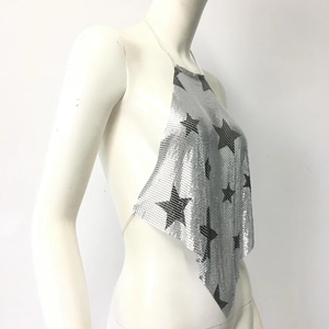Side view of silver metal mesh halter top with black star patterns and tie-back detail