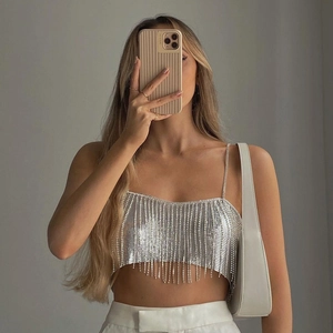 Close-up of a silver sequin tassel crop top with metallic fringe and thin chain straps