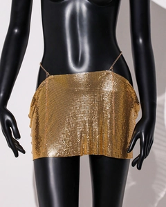 Close-up of golden metallic sequin mini skirt with delicate chain link mesh texture