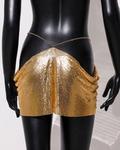 Detailed view of the gold metallic sequin mesh fabric on a sexy mini skirt
