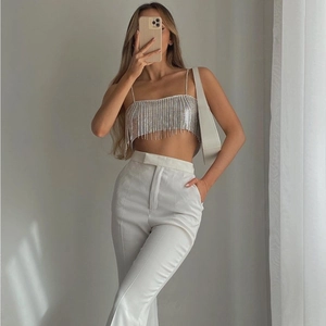Detailed view of silver sequin crop top with long fringes and thin shoulder straps