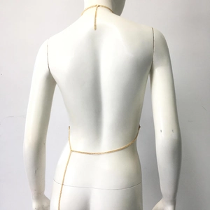 Detailed view of minimalist gold metal body chain on mannequin back with neck and waist links