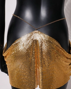 Macro detail of golden metal mesh skirt featuring hexagon sequins and chain links