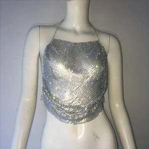 Macro detail of silver sequin mesh fabric and sparkling rhinestones on halter top
