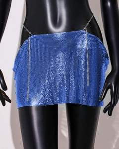 Detail of bright blue metal mesh mini skirt featuring round sequins and silver chains