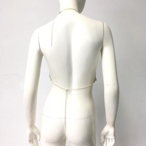 Detail of silver rhinestone body chain with layered back drop chains on white mannequin