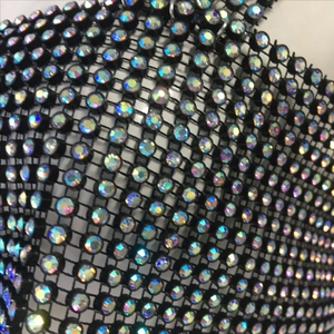 Détail macro de strass AB irisés sur tissu en maille noire pour hauts sexy de fête