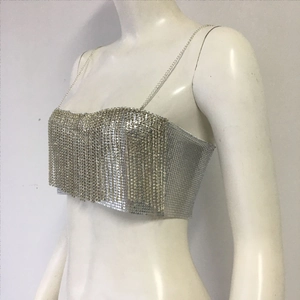 Detail of silver sequin crop top featuring metallic fringe and thin chain straps