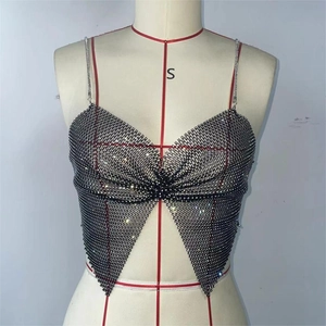 Detail of black mesh camisole with rhinestones, bow-shaped bust, and silver chain straps