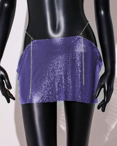 Close-up of bright purple metal mesh mini skirt with shiny sequins and chain belt
