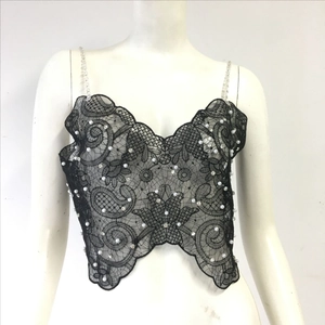 Detail of black lace camisole featuring white pearls and sparkling rhinestone decorations
