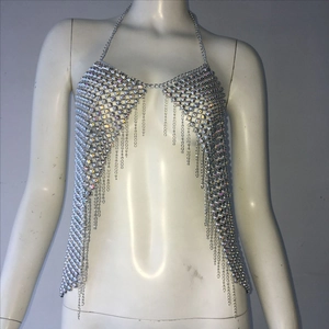 Detail of silver rhinestone halter top with glittering metal chains and fringe tassels