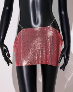 Detailed close-up of pink chainmail mini skirt with metallic mesh and chain waist strap