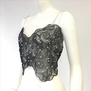 Close-up of black lace camisole top with white pearls and sparkling rhinestone details